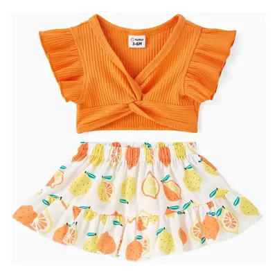 2pcs Baby Girl Solid Cotton Ribbed Ruffle-sleeve Twist Knot Crop Top and Allover Fruit Print Ski