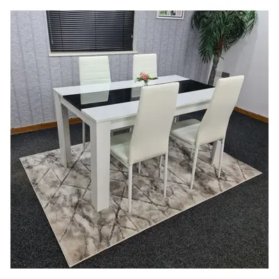 White and black wood dining table with white faux leather chairs